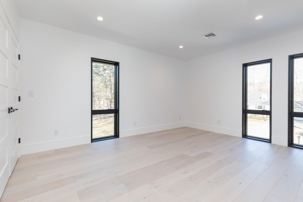 11 Willard Road Weston, MA 02493 - Photo 32 of 42 an empty room with wooden floor and windows