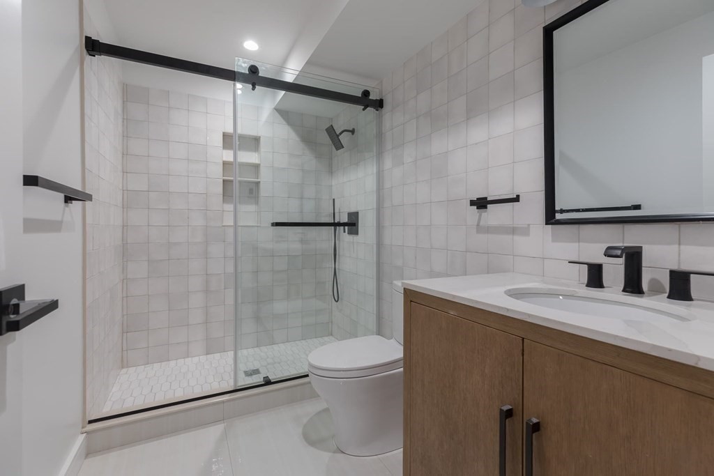 11 Willard Road Weston, MA 02493 - Photo 36 of 42 a bathroom with a granite countertop sink toilet and shower