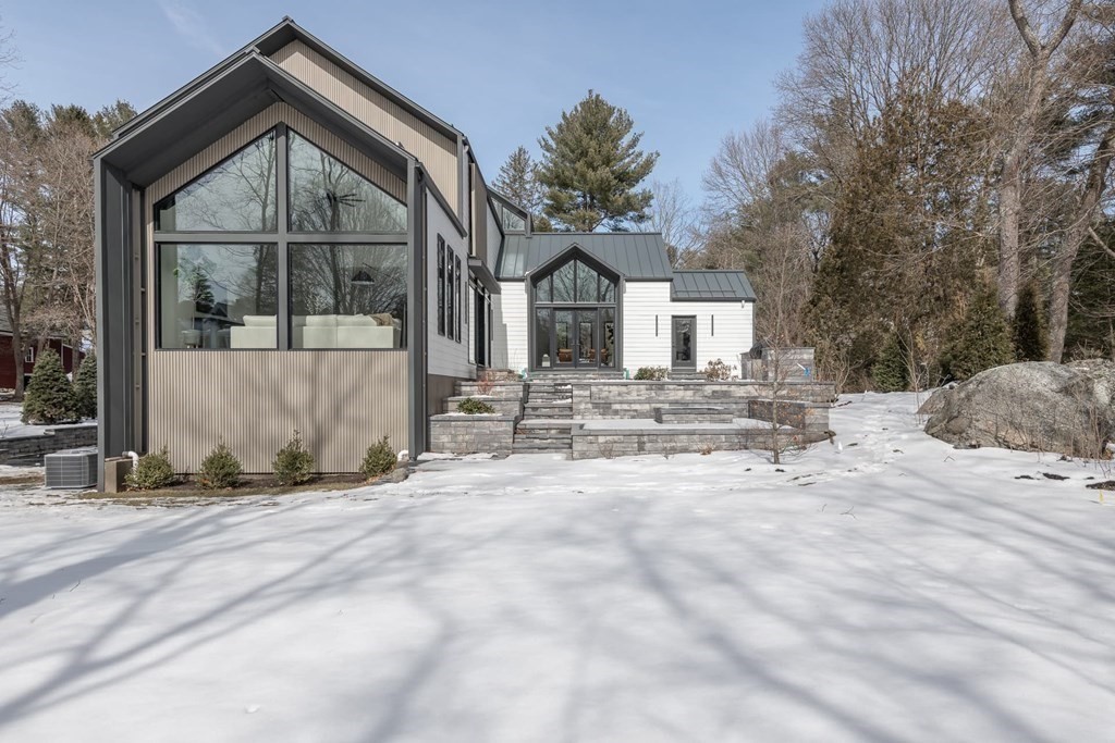 11 Willard Road Weston, MA 02493 - Photo 40 of 42 a front view of a house with a yard covered with snow in front of house