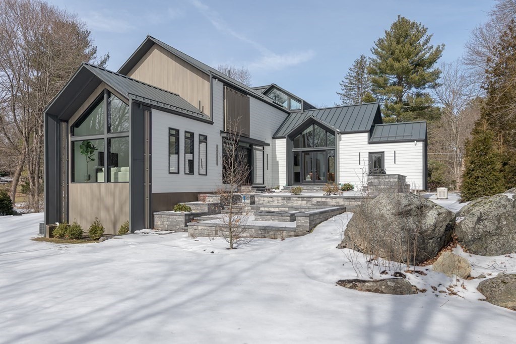 11 Willard Road Weston, MA 02493 - Photo 42 of 42 a view of a white house with a large tree and wooden fence