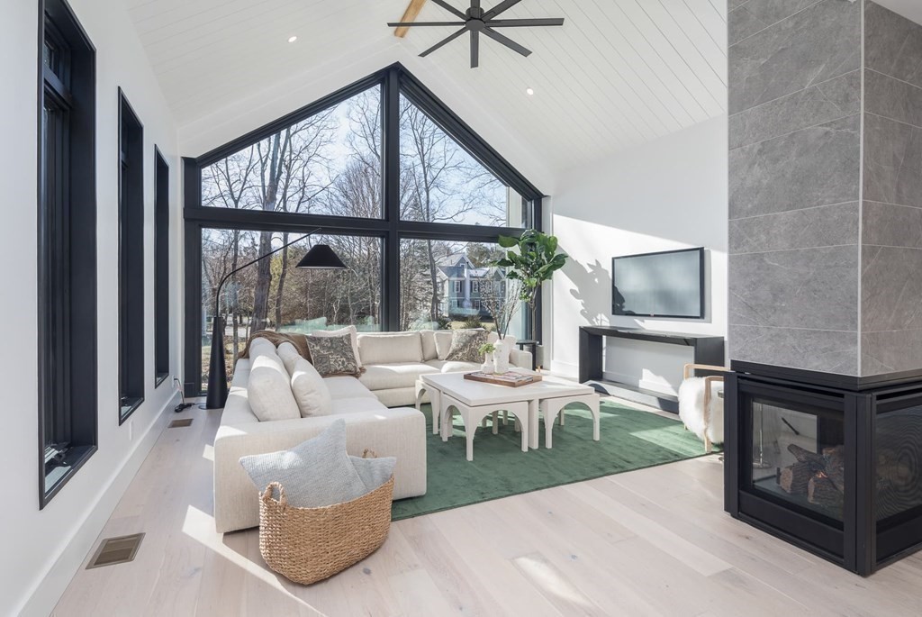 11 Willard Road Weston, MA 02493 - Photo 8 of 42 a living room with furniture tv and a floor to ceiling window