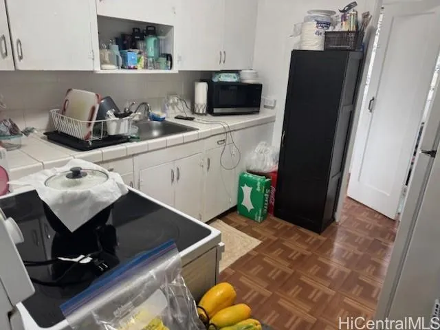 a kitchen with a sink and a refrigerator