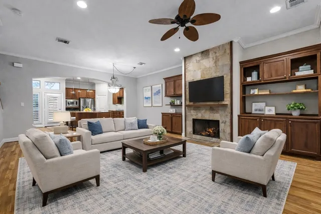 a living room with furniture a fireplace and a flat screen tv
