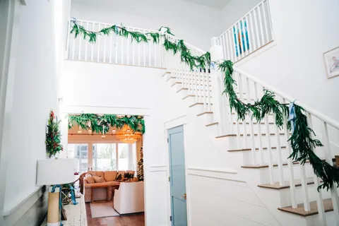 a living room with furniture a flat screen tv and a large window