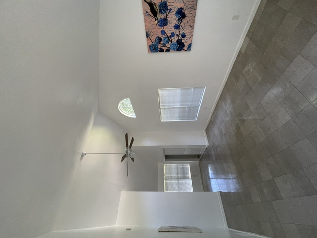 4611 Glissman Road Austin, TX 78702 - Photo 4 of 11 High ceilings and sun-filled interiors define this grand living space with skylights and elegant flooring.
