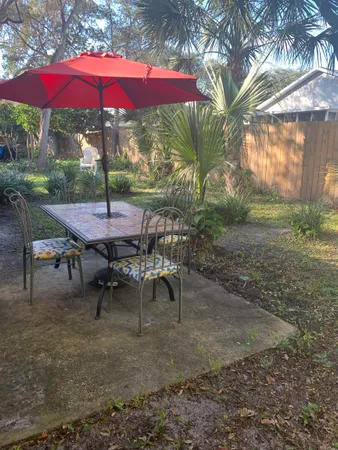 a view of a backyard with a patio and outdoor seating