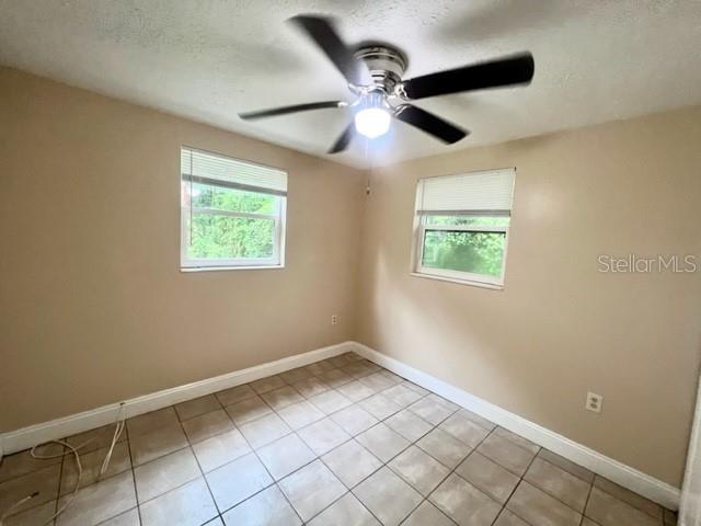9418 Greystone Road Thonotosassa, FL 33592 - Photo 14 of 19 a view of an empty room with a window