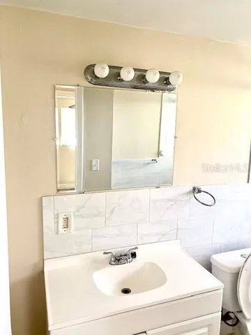 a bathroom with a sink and a mirror