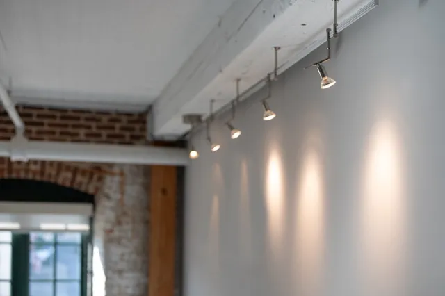 a view of an empty room with a chandelier fan