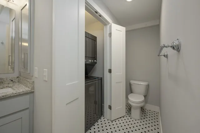 a bathroom with a black and white checkered floor