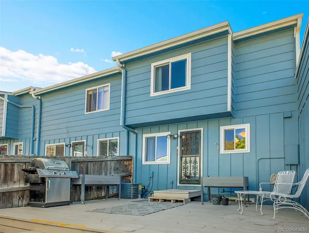 a front view of a house with sitting area