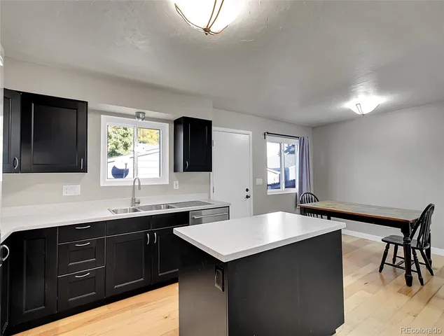a kitchen with a sink and cabinets
