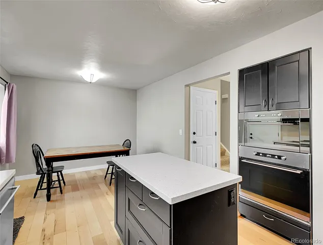 a kitchen with a stove a sink and a refrigerator