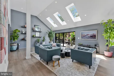 a kitchen with stainless steel appliances kitchen island granite countertop a table chairs and a refrigerator