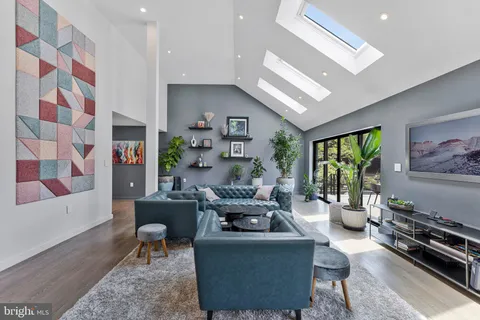 a kitchen with stainless steel appliances granite countertop a stove a sink dishwasher a dining table and chairs with wooden floor