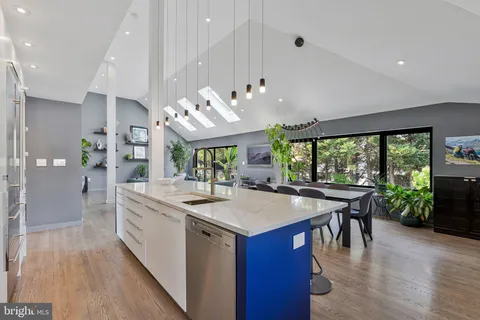 a kitchen with a sink stainless steel appliances and cabinets