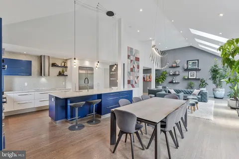 a living room with kitchen island granite countertop furniture and a kitchen view