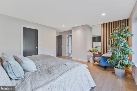 a spacious bedroom with a bed and a large window