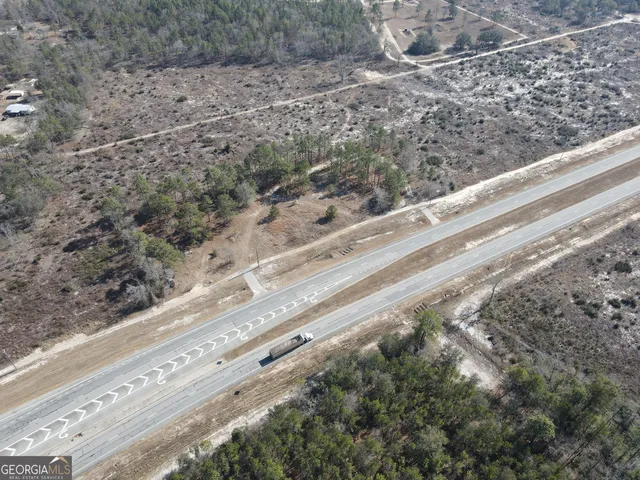 a view of a yard with wooden fence