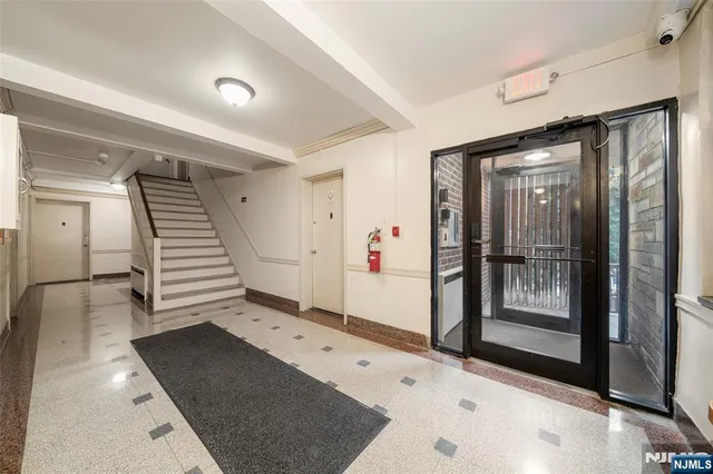 a view of a hallway with entryway wooden floor and front door