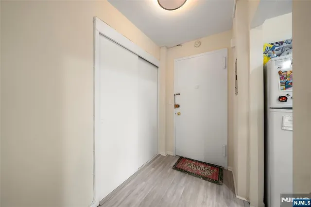 a view of an entryway with wooden floor