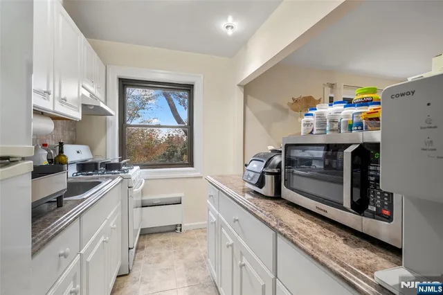 a kitchen with a sink stove and microwave