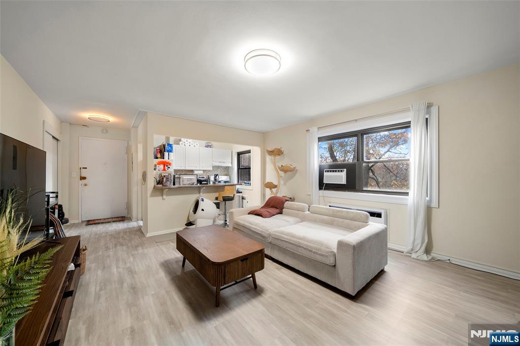 3040 Edwin Avenue, Unit 4A Fort Lee, NJ 07024 - Photo 9 of 15 a living room with furniture a flat screen tv and a window