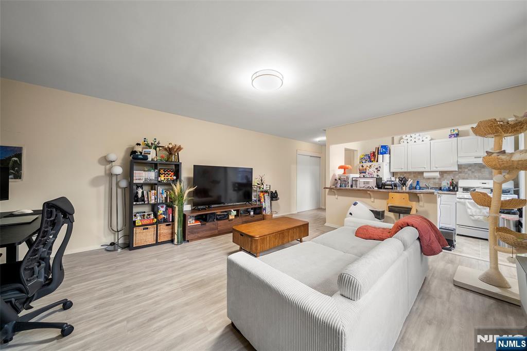 3040 Edwin Avenue, Unit 4A Fort Lee, NJ 07024 - Photo 10 of 15 a living room with furniture and a flat screen tv