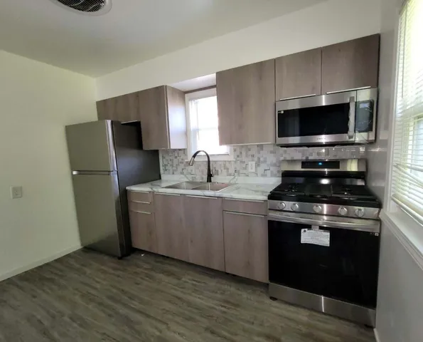 a kitchen with a sink a stove and a refrigerator