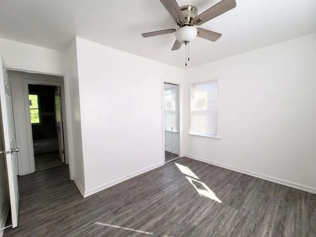 wooden floor in an empty room with a window