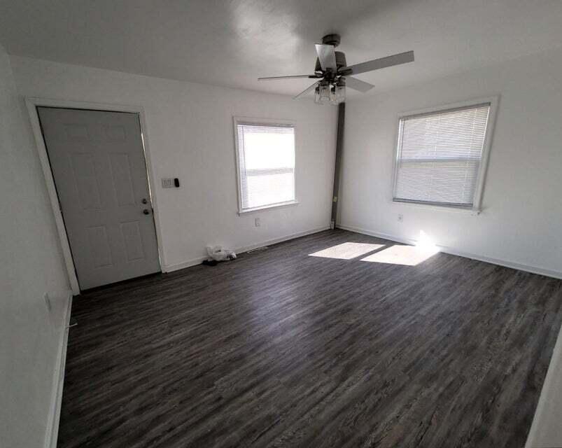 2267 Tennessee Street Gary, IN 46407 - Photo 5 of 11 an empty room with wooden floor fan and windows