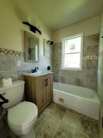 a bathroom with a sink a toilet and bathtub