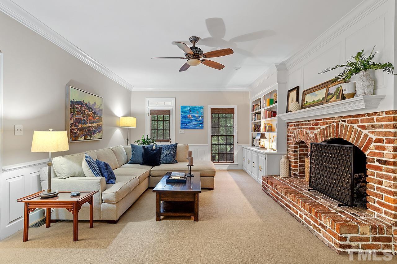 717 Presnell Court Raleigh, NC 27615 - Photo 14 of 36 a living room with furniture a fireplace and a flat screen tv