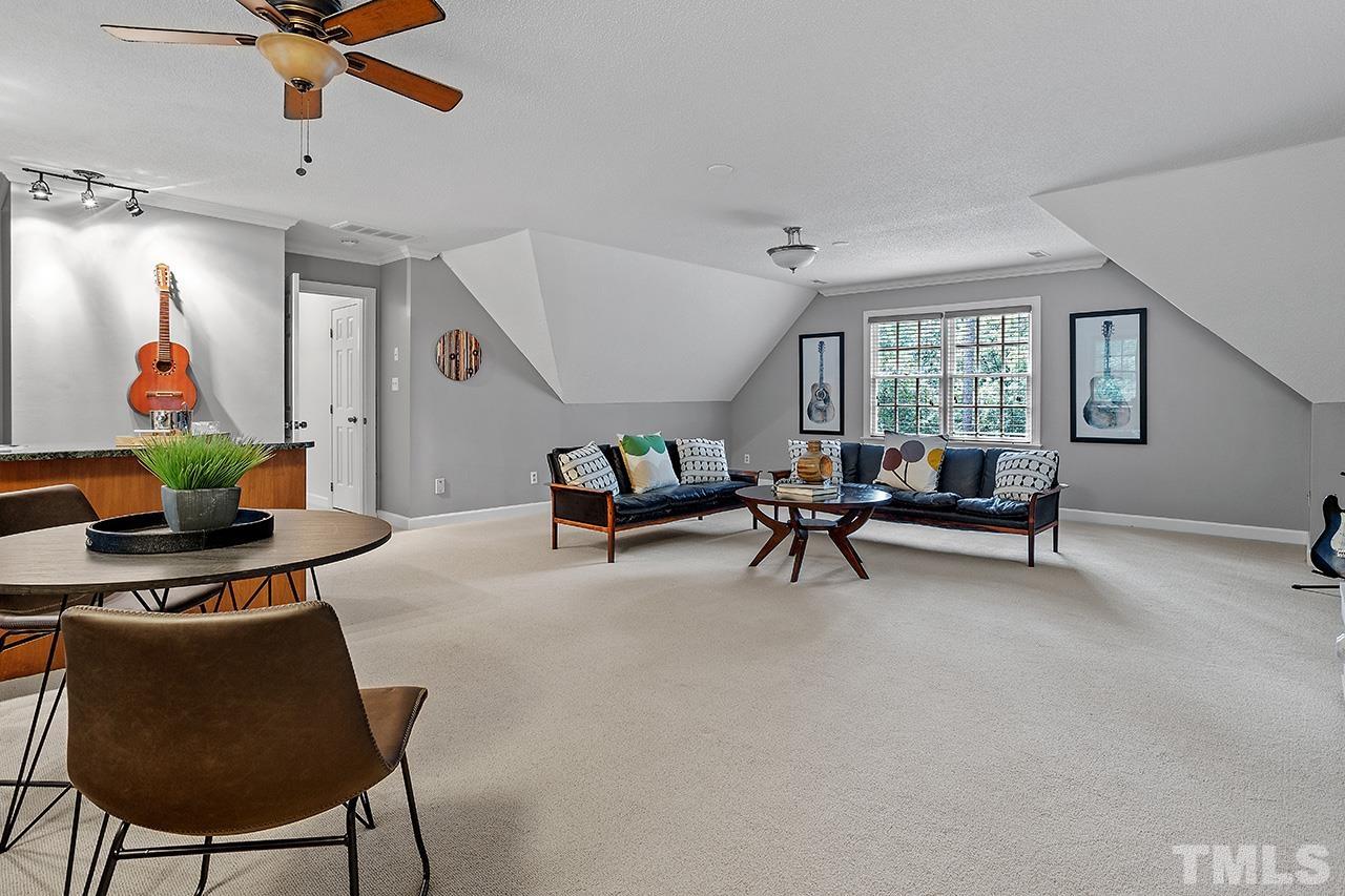 717 Presnell Court Raleigh, NC 27615 - Photo 27 of 36 a living room with furniture and a ceiling fan