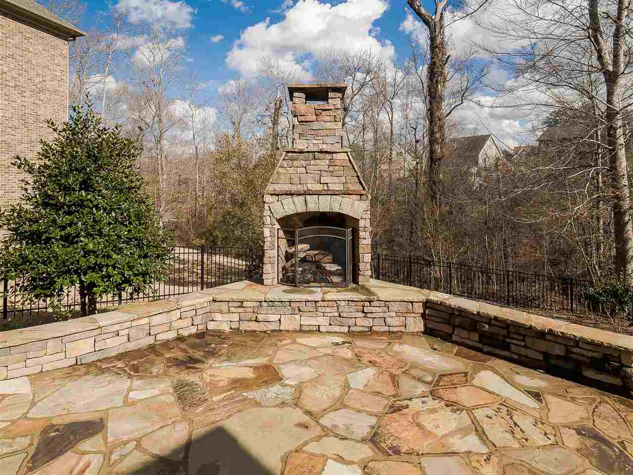 3004 Royal Forrest Drive Raleigh, NC 27614 - Photo 22 of 25 Outdoor entertaining at its best. Love sitting quietly around your 10 foot stacked stone fireplace watching nature. Cool nights making smores. Out door dining or pillows for casual seating on your stone patio. Fenced yard with three gates. Exterior Back