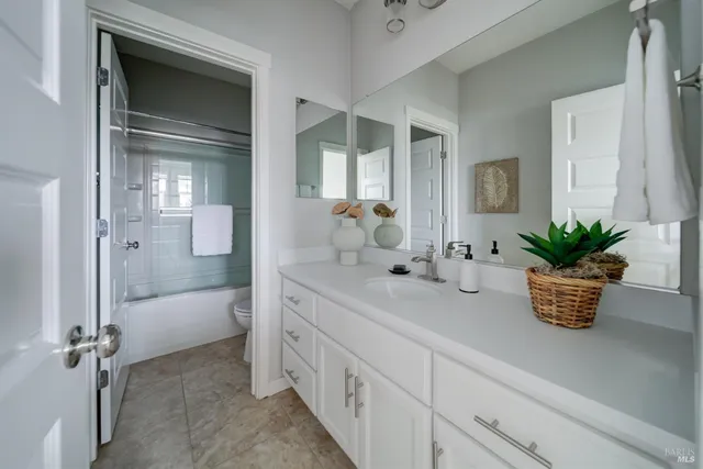a bathroom with a tub a sink and mirror