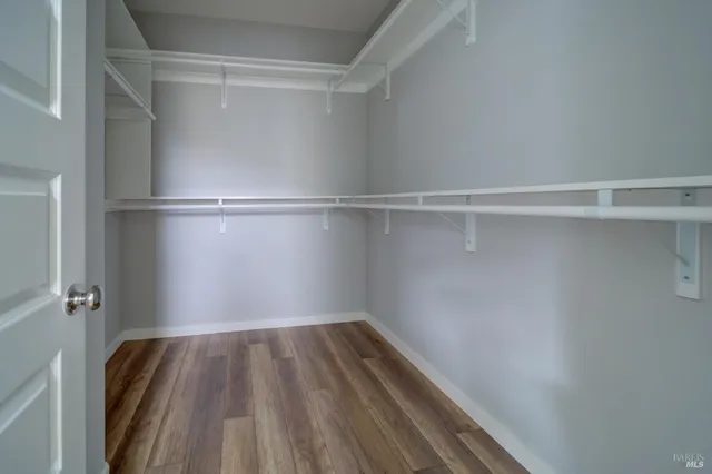 a view of walk in closet with empty racks