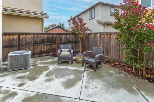 a building outdoor space with patio furniture and potted plants