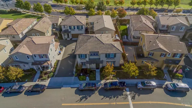 an aerial view of a house with a yard and outdoor seating