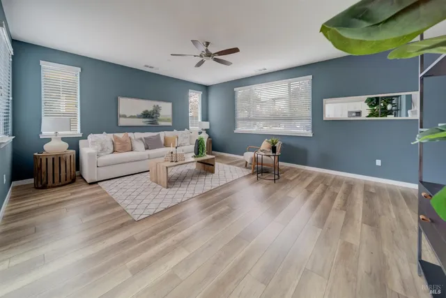 a living room with furniture and a wooden floor