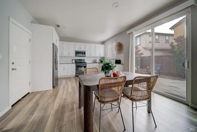a dining room with furniture and window
