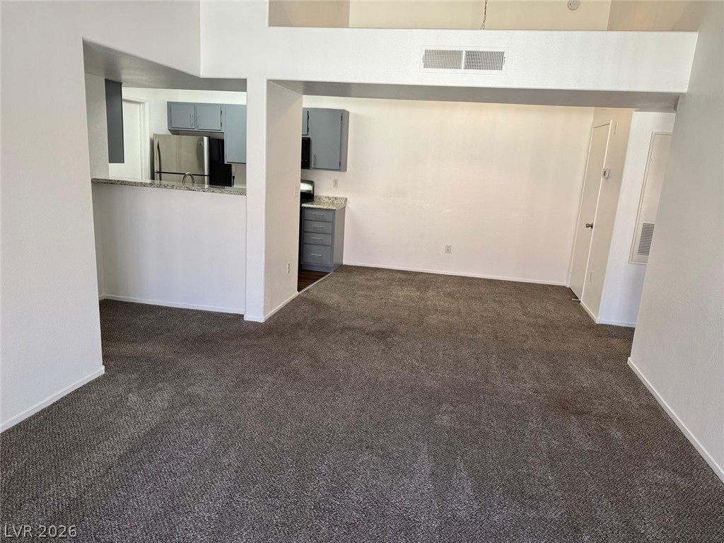 7885 West Flamingo Road, Unit 2171 Las Vegas, NV 89147 - Photo 22 of 22 An open floorplan living area flows seamlessly into the kitchen, featuring modern appliances and a convenient breakfast bar.
