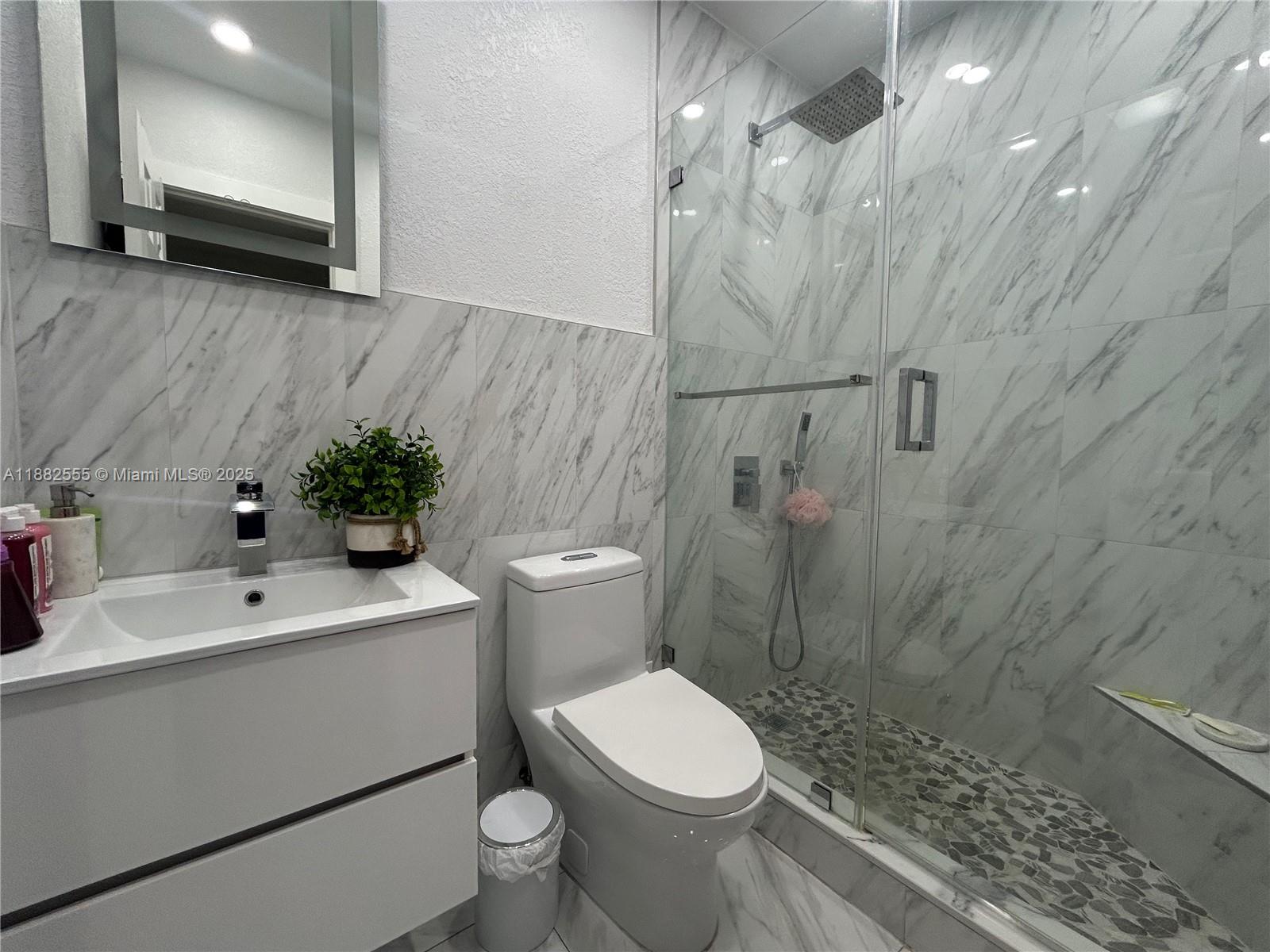 460 East 23rd Street, Unit 103 Hialeah, FL 33013 - Photo 11 of 20 a bathroom with a sink a toilet and shower