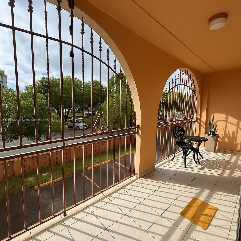 460 East 23rd Street, Unit 103 Hialeah, FL 33013 - Photo 15 of 20 a view of a balcony with chairs