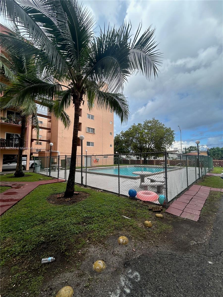 460 East 23rd Street, Unit 103 Hialeah, FL 33013 - Photo 18 of 20 a view of a backyard with swimming pool