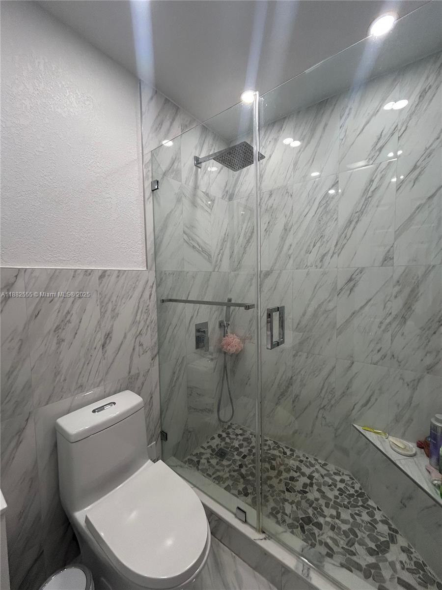 460 East 23rd Street, Unit 103 Hialeah, FL 33013 - Photo 10 of 20 a bathroom with a toilet and a shower