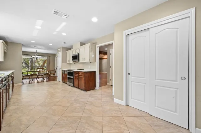 a large white kitchen with cabinets and a stainless steel appliances