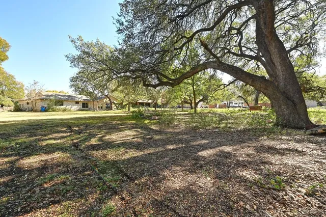 a front view of a house with a yard garage and outdoor seating