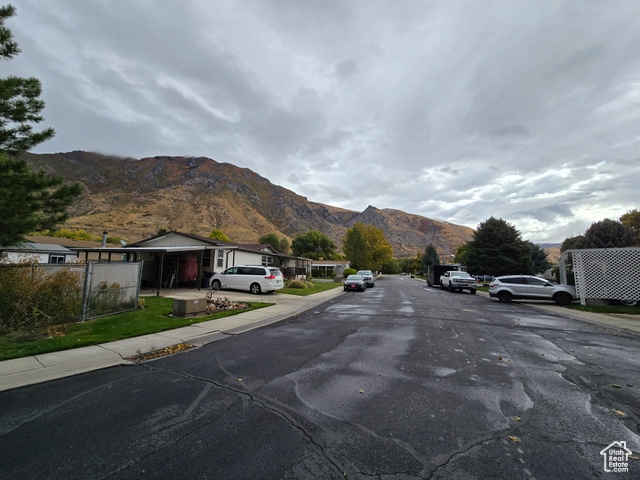 1025 North 300 West, Unit 1 Springville, UT 84663 - Photo 35 of 35 View of asphalt road with a mountain view, sidewalks, and curbs