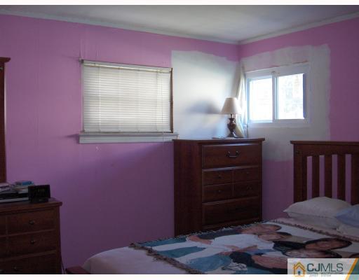 53 Tunison Road New Brunswick, NJ 08901 - Photo 7 of 10 a bathroom with a sink and a mirror